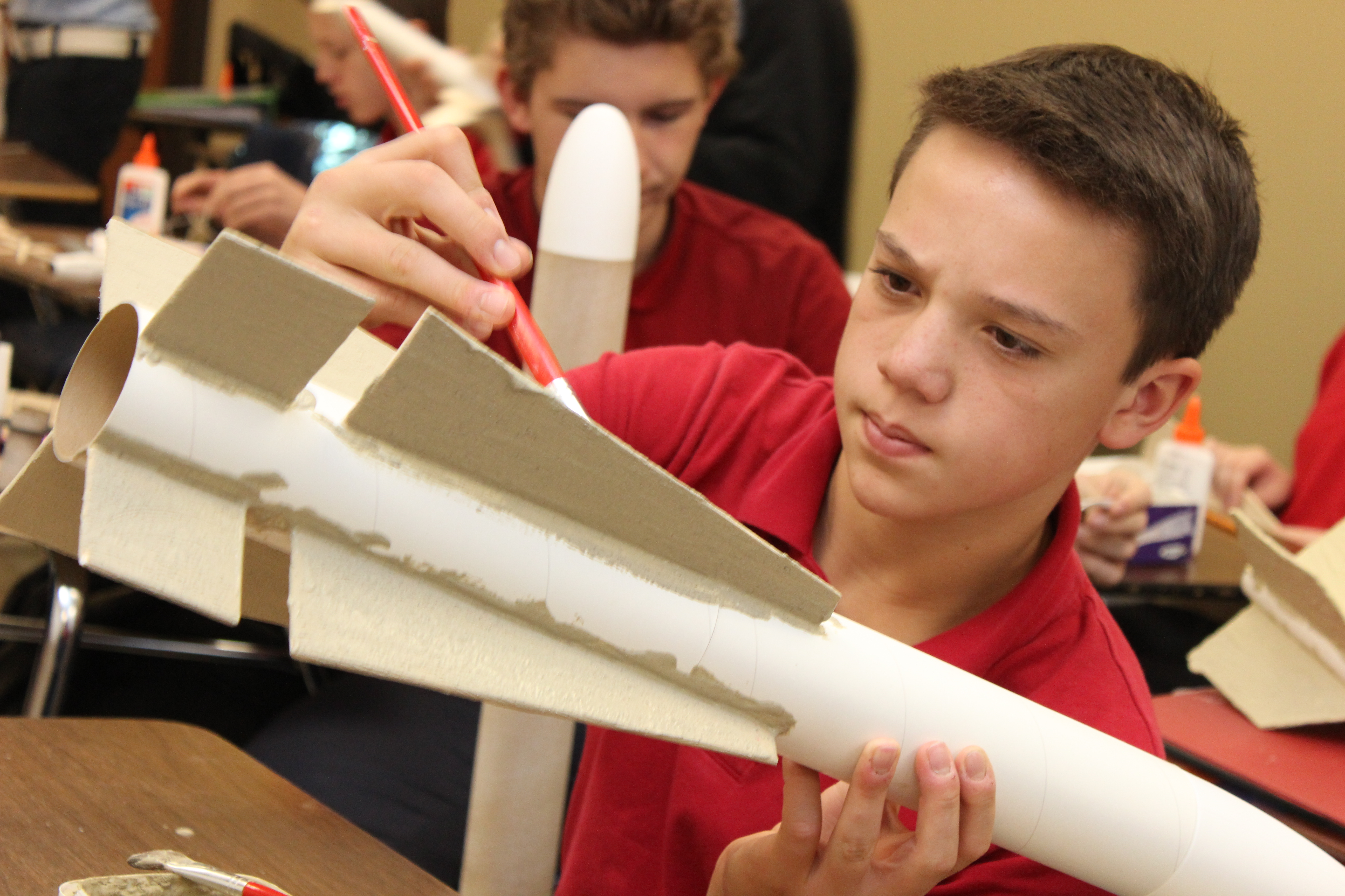 a student of the vanguard school building a rocket in the tarc club