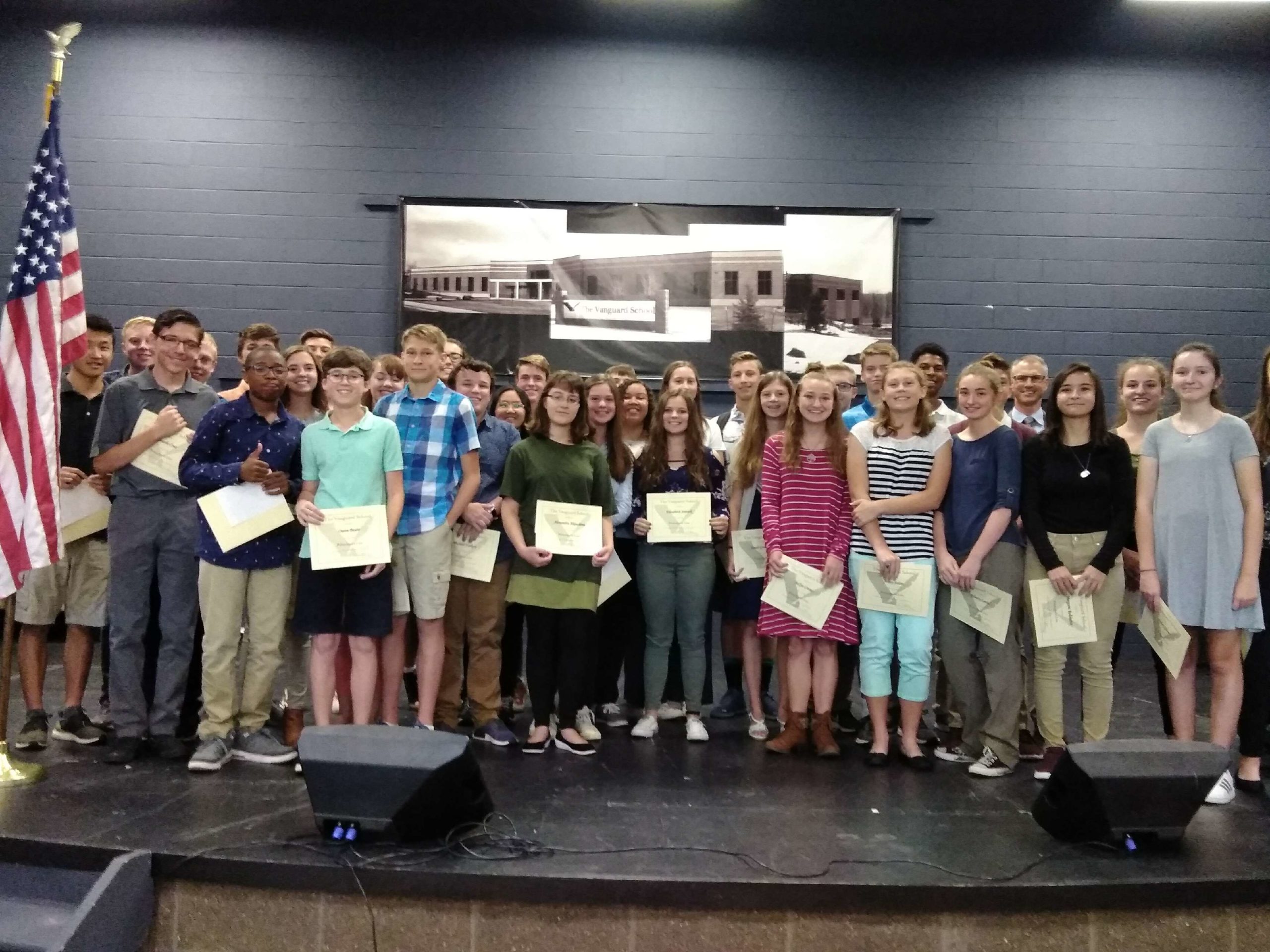 The Vanguard School student leaders standing on stage accepting leadership awards.