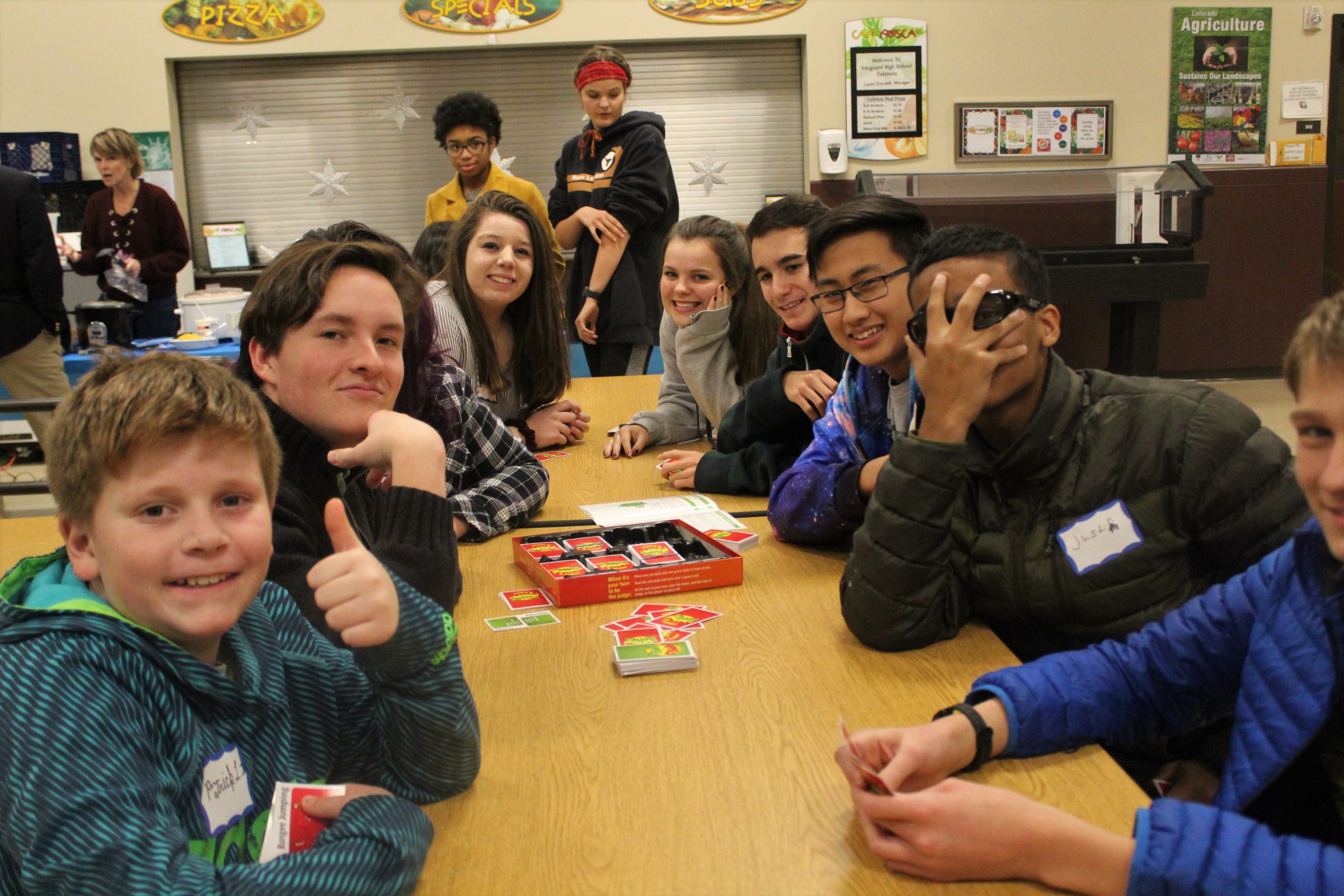 Vanguard students smiling at the camera after enrollment.